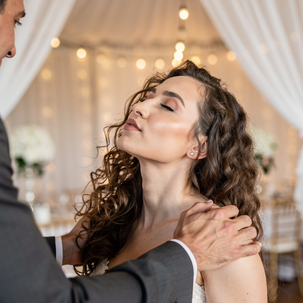He takes her by the shoulders and kisses her passionately.